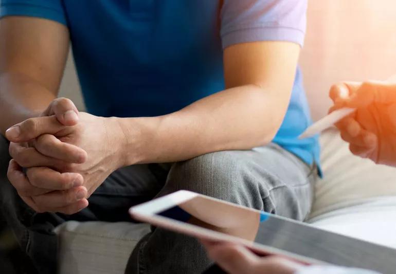 Doctor counseling male patient on showave therapy