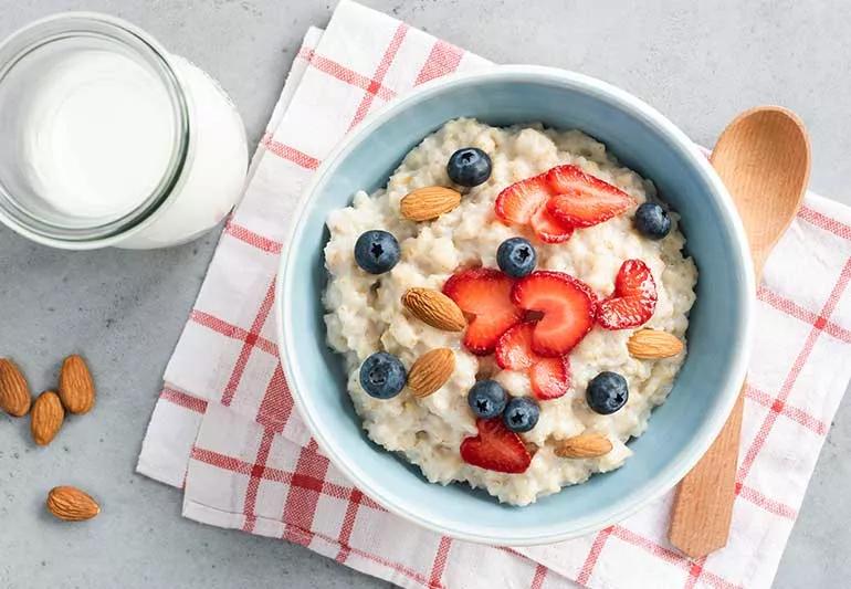 Bowl of oatmeal with strawberries and blueberries.