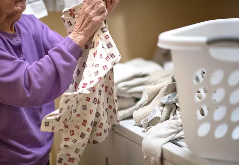 Woman folding her newly washed clothes