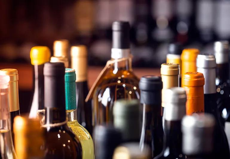 variety of wine bottles on table