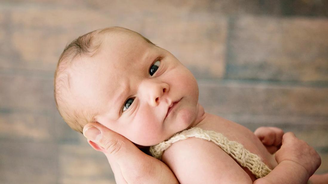 Newborn baby with crossing eyes