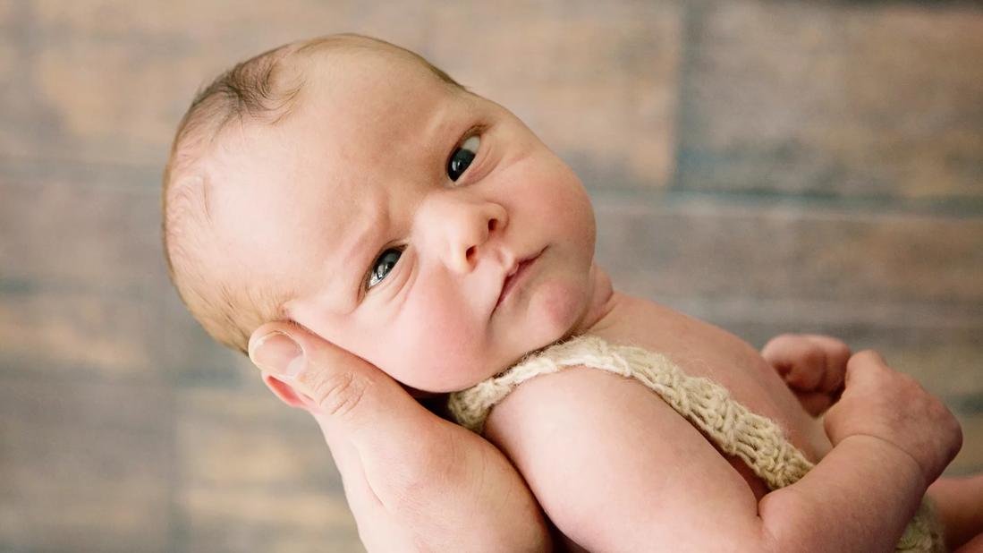 Newborn baby with crossing eyes