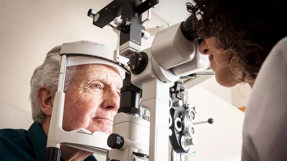 Eye doctor looking into a man's eye