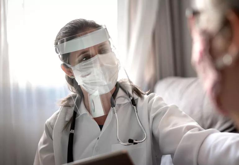 healthcare worker wearing a face shield with mask