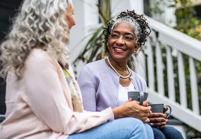 Women sit on steps and talk boundaries in relationships