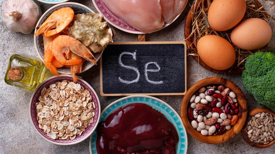 Assorted foods with selenium on plates and in bowls, with chalkboard with SE on it