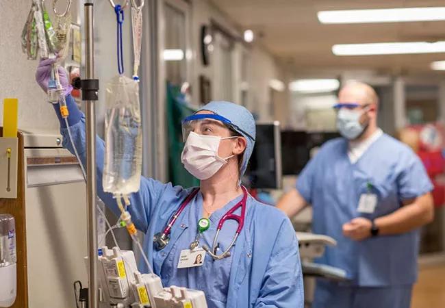 Nurse conducts safety check on medications in hospital hallway