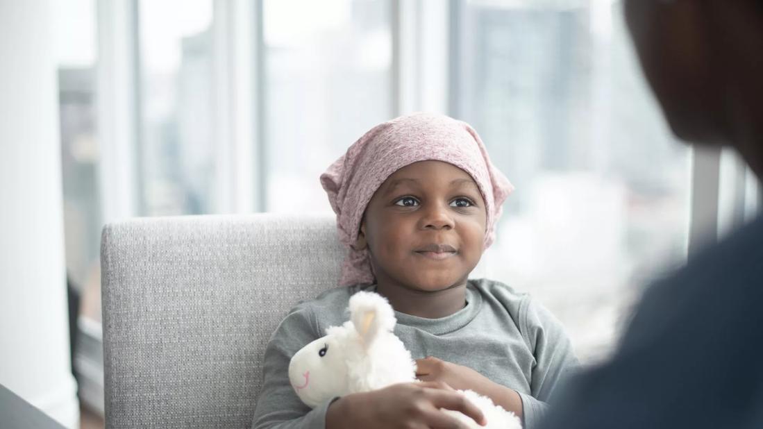 Little boy with cancer sitting in chair