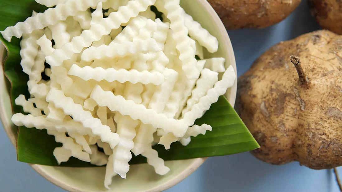 Jicama fries in a bowl, with whole jicama on table