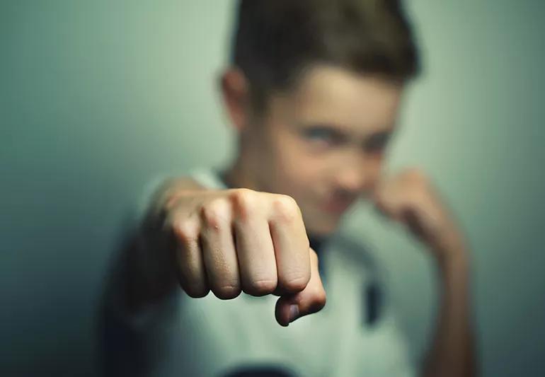 Angry child boy in white t-shirt