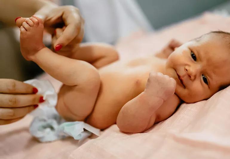 Baby having diaper changed