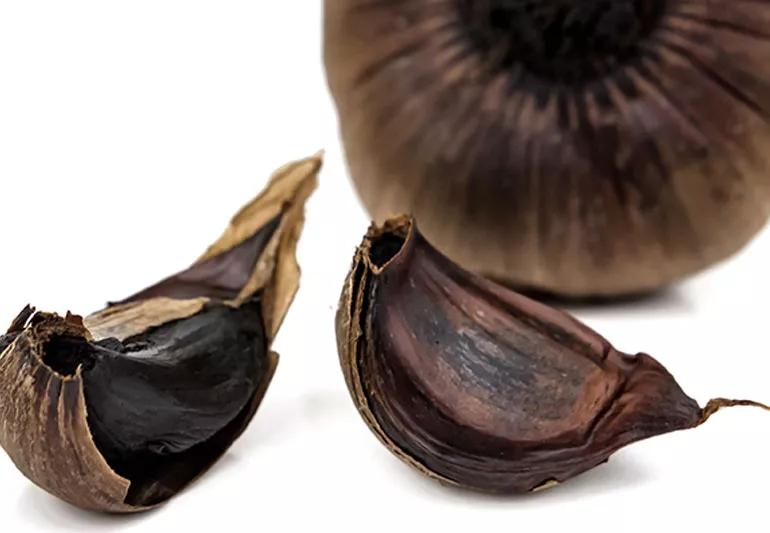 A close-up of black garlic cloves.