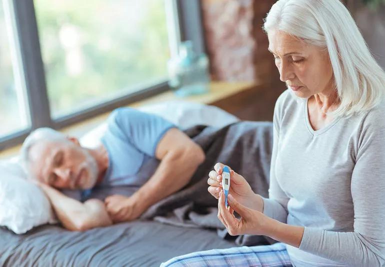 concerned wife takes husbands temperature flu season heart