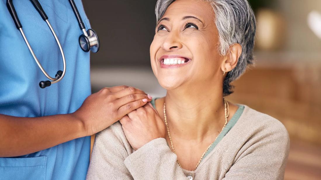 Nurse laughing with elderly patient
