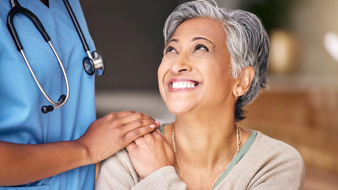 Nurse laughing with elderly patient