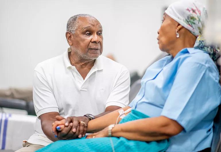man comforting wife receiving cancer treatment
