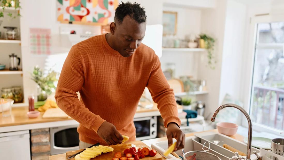 Person prepping different foods in kitchen