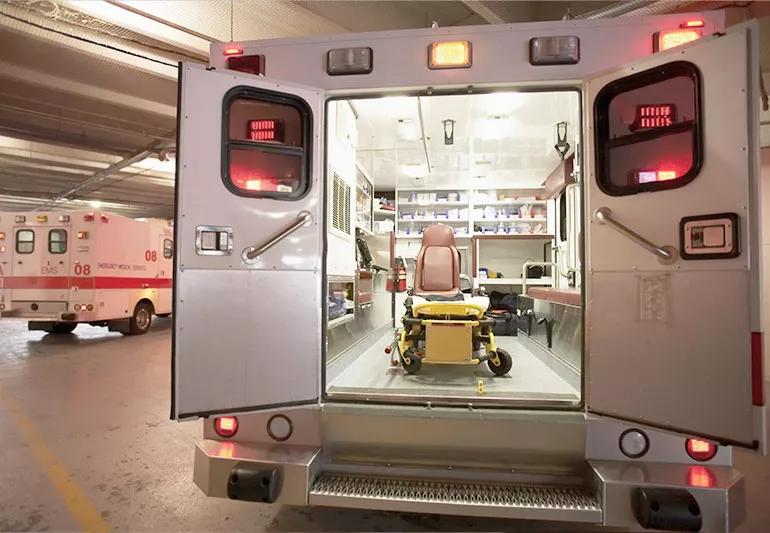 looking inside the back of an ambulance with an empty stretcher inside