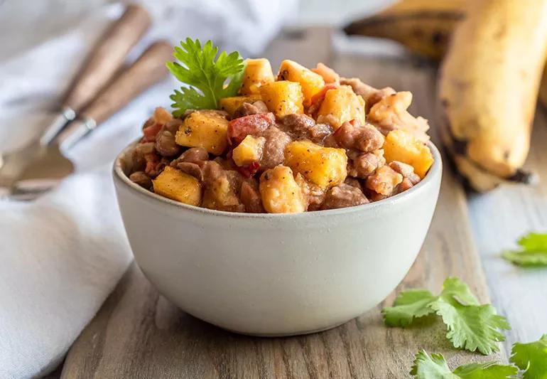 Heaping bowl of Caribbean-style pink beans with plantains