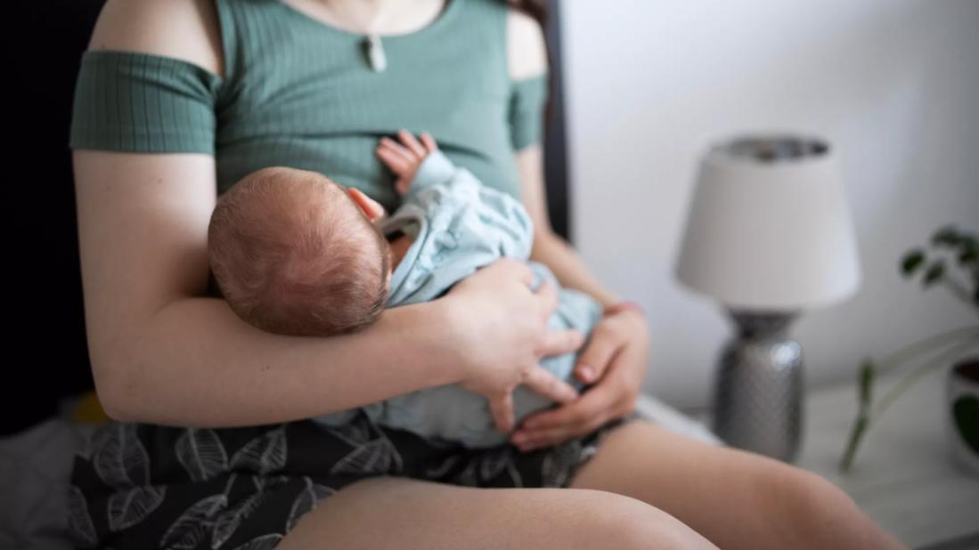 Female breast feeding baby