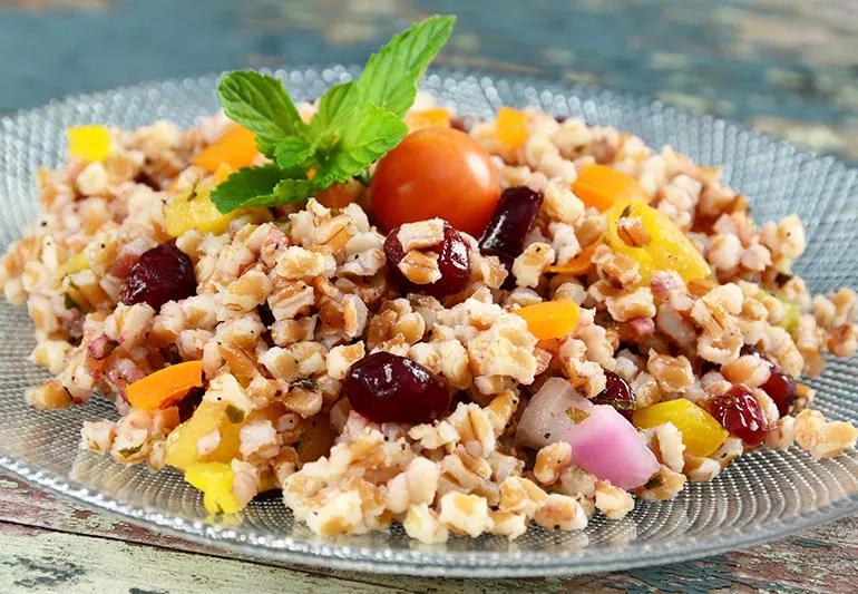 wheat berry salad on a glass plate