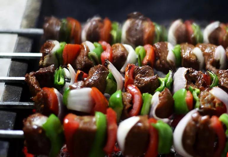 Closeup of steak and veggie kabobs on the grill.