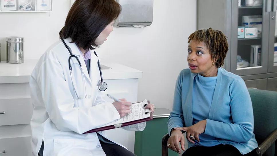Female patient at doctor office discussing concerns and issues