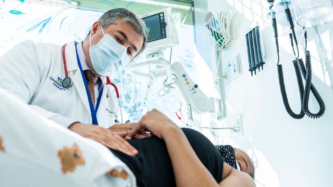 Clinician looking down at patient on exam table
