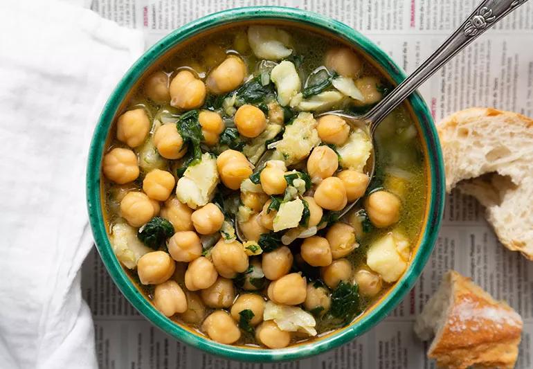 A bowl of chickpeas with sautéed spinach