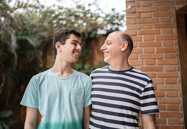 A child and parent smiling at each other