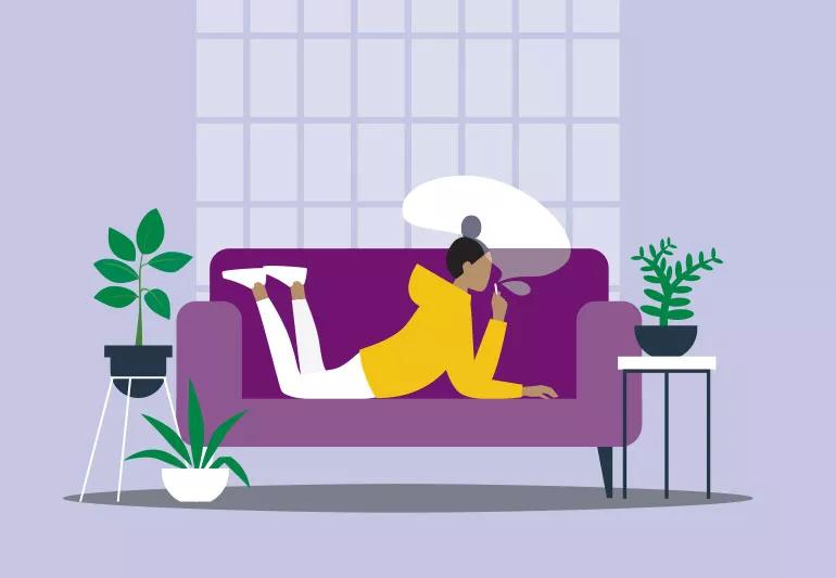 woman smoking while lying on couch