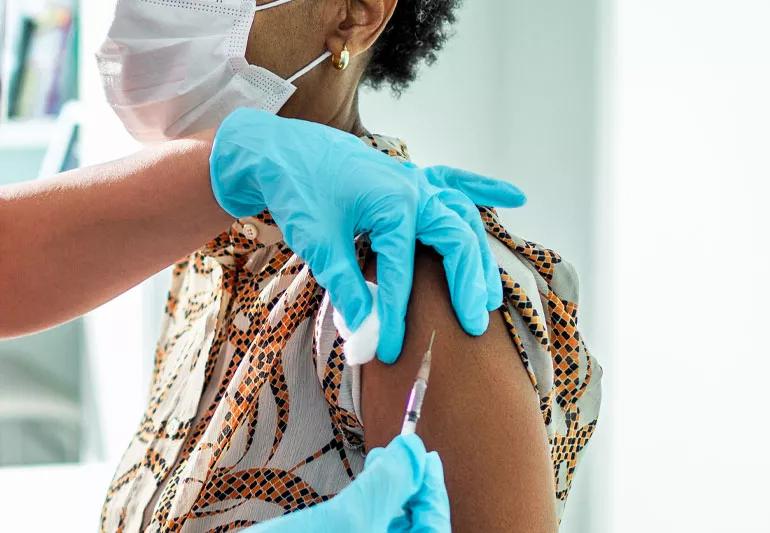 Person in doctor's office getting vaccinated.