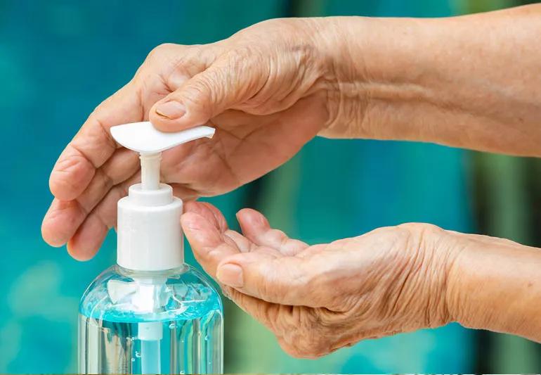 woman using hand sanitizer