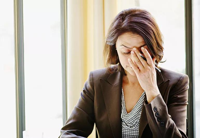 woman at work suffering from a tension headache