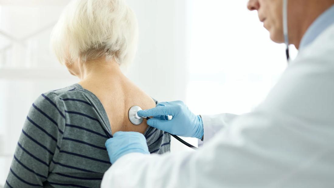 Doctor listening to patient with stethoscope