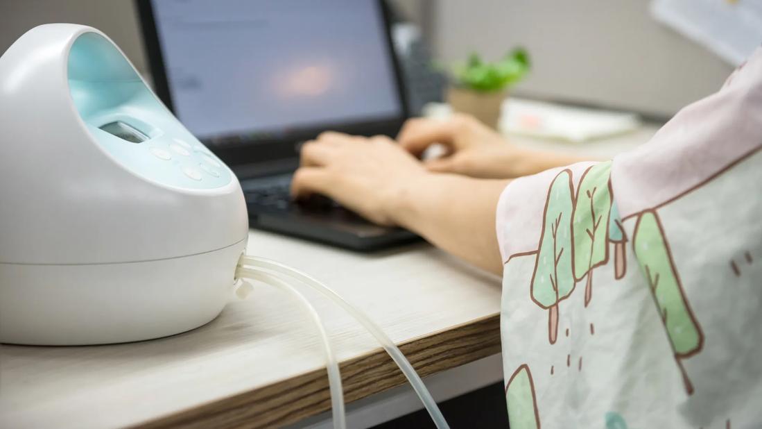 Person using breast pump machine while at work