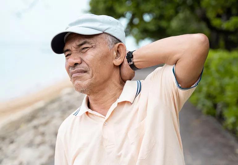 Elderly man suffering from neck pain