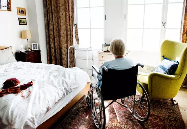 Holding elderly patient's hands