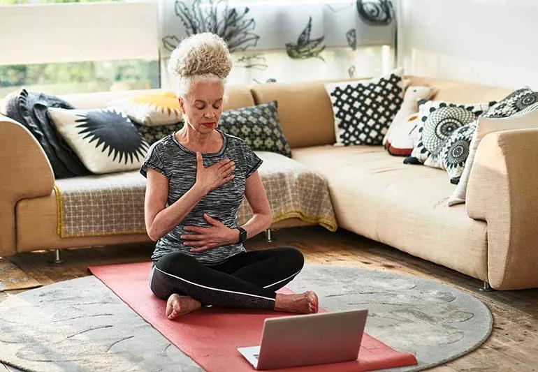 person deep breathing during yoga