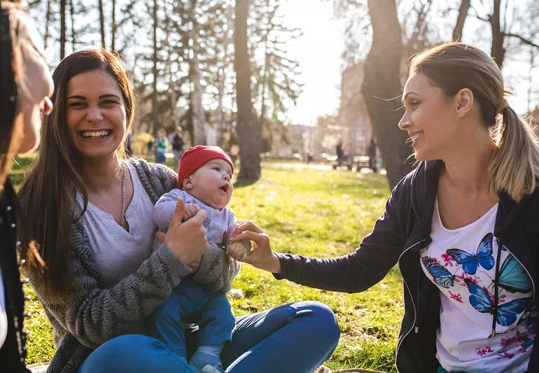 Woman enjoying playing with friend's baby
