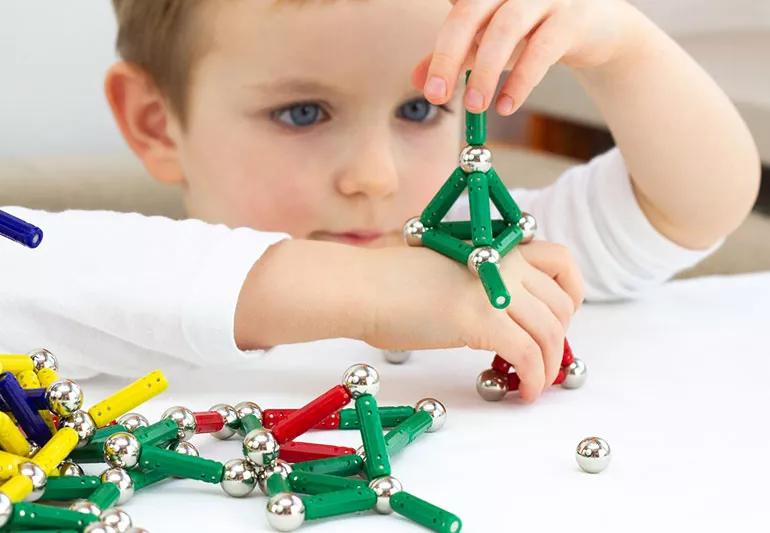 child playing with magnets