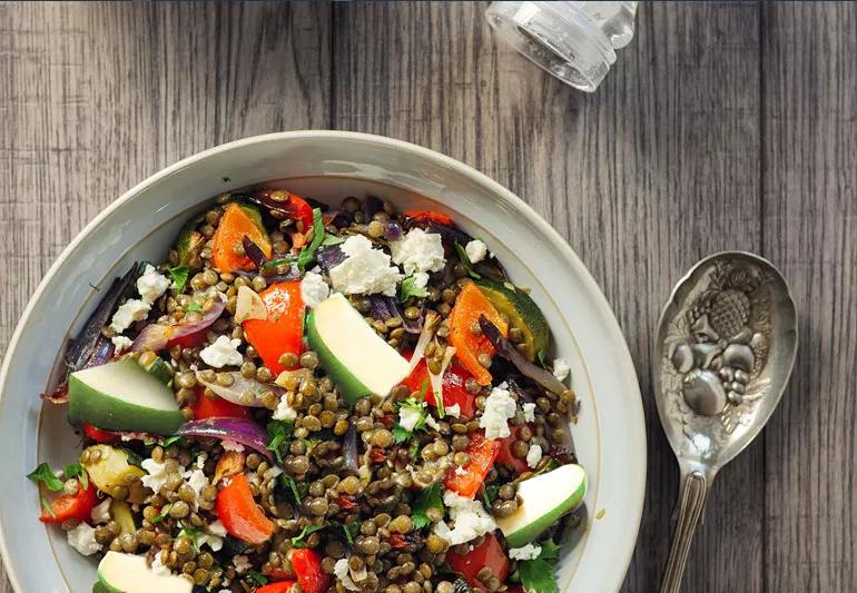 Lentils, tomatoes and apples in a salad bowl.