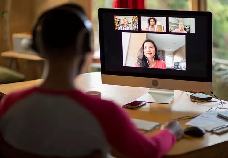 Someone meets with their coworkers over Zoom for a conference call.