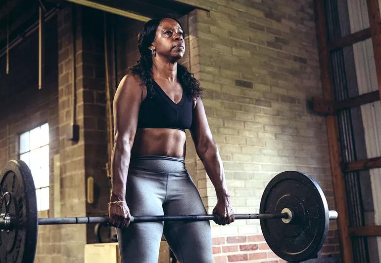 woman training with barbells
