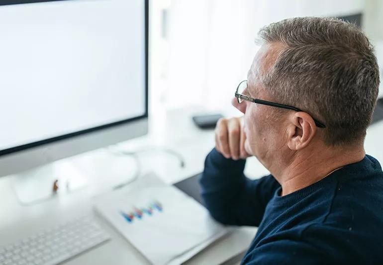 Male researching on computer.