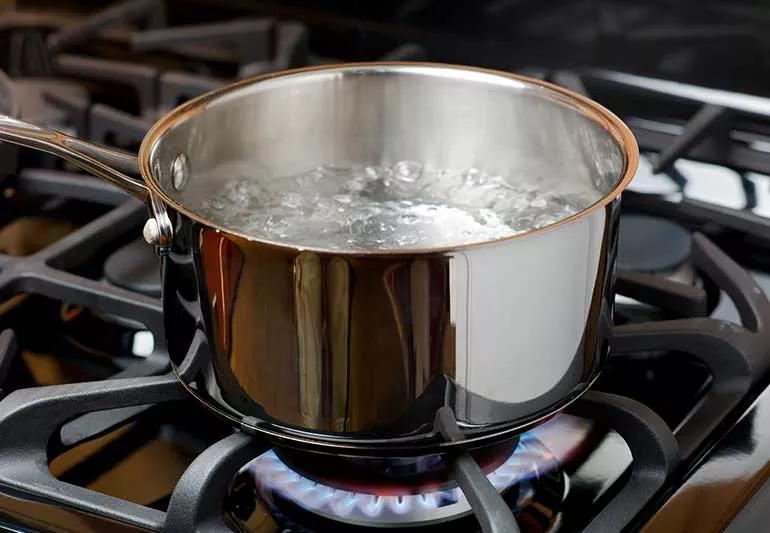 Boiling water on stove top.