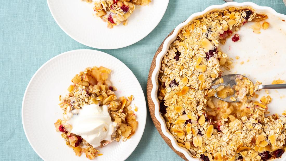 Two serving plates with winter fruit gratin, with serving dish