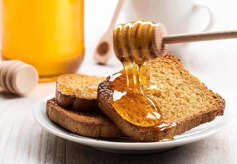 honey being dribbled on toast