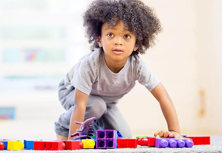 toddler playing with legos