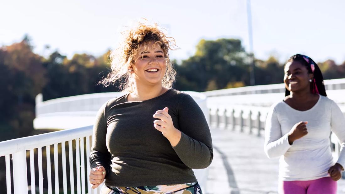 Female and friend jogging outside